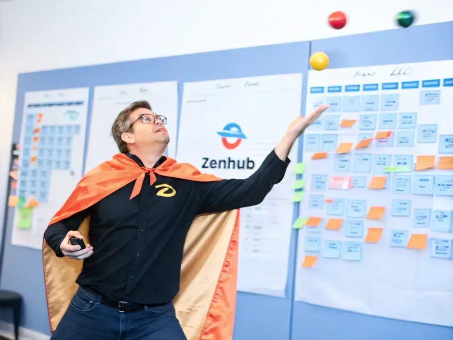 Zenhub employee in superhero cape managing project tasks on a board