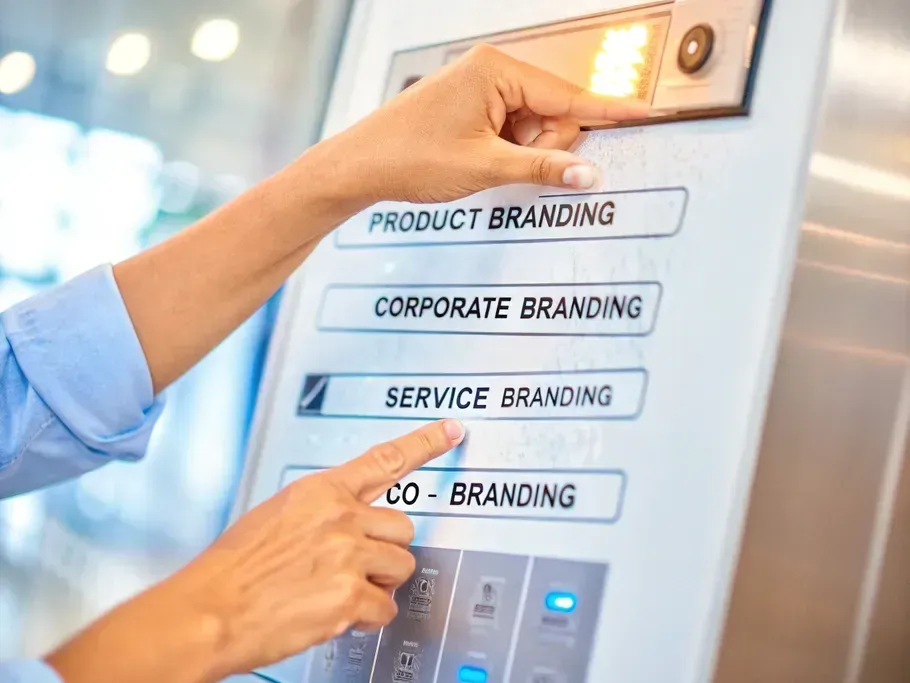 A hand selecting a strategy button on a futuristic control panel with options for different types of branding.
