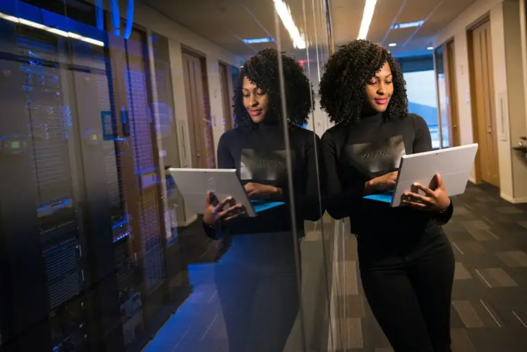 Professional woman reviewing data on a tablet, reflecting expertise.