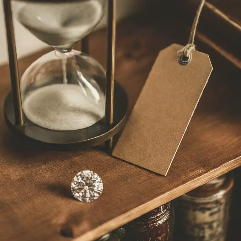 A close-up view of an hourglass with sand running, a blank tag, and a brilliant-cut diamond on a wooden shelf, symbolizing time, value, and strategic planning in business.