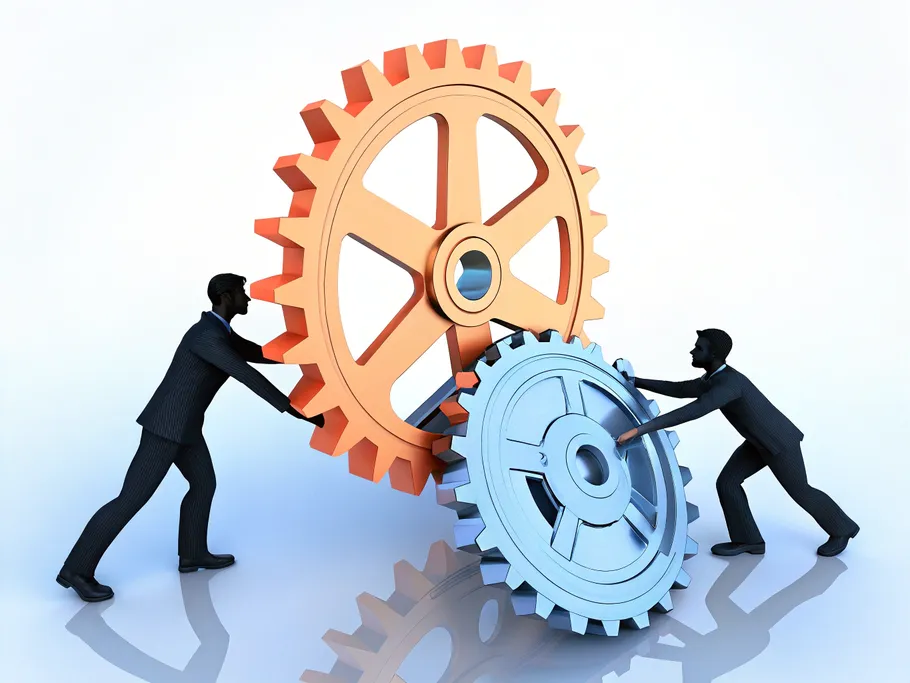 Two men integrating interlocking gears symbolizing collaboration in a business partnership