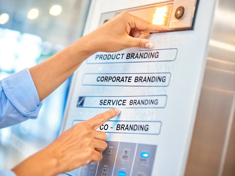 A hand selecting a strategy button on a futuristic control panel with options for different types of branding.